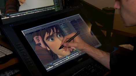 a hand drawing a cartoon face on a screen