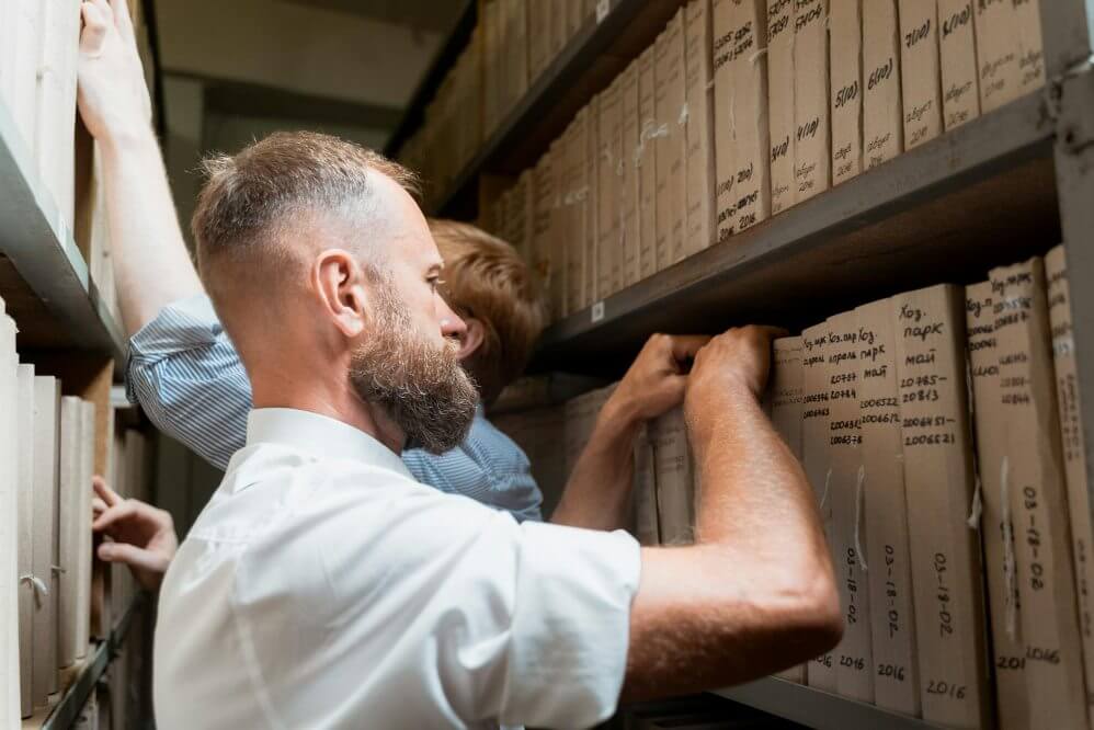 Archivist (1) A man looking at the books in an archive