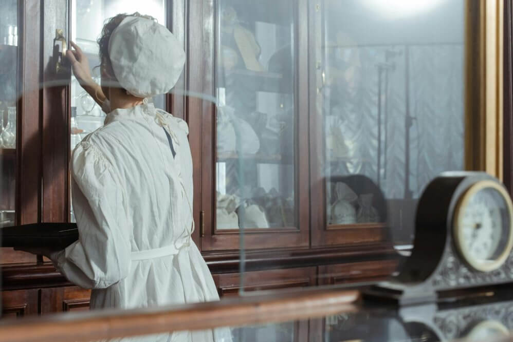 curator (1) a curator cleaning a glass cabinet