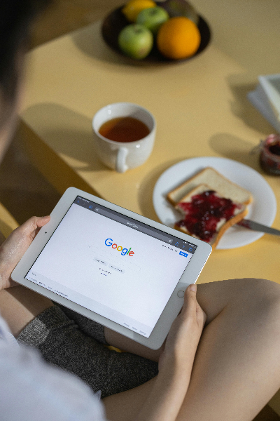 a person on a tablet with the google homepage on