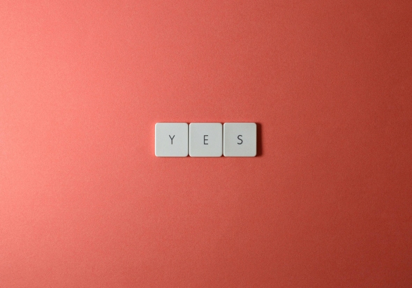 img2 yes spelled with scrabble blocks on a peach background