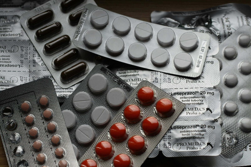packet-of-tablets packets scattered about containing red and white tablets