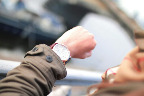 a person checking the watch on his/her wrist