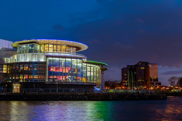 Night picture of the Lowry illuminated by the quays.