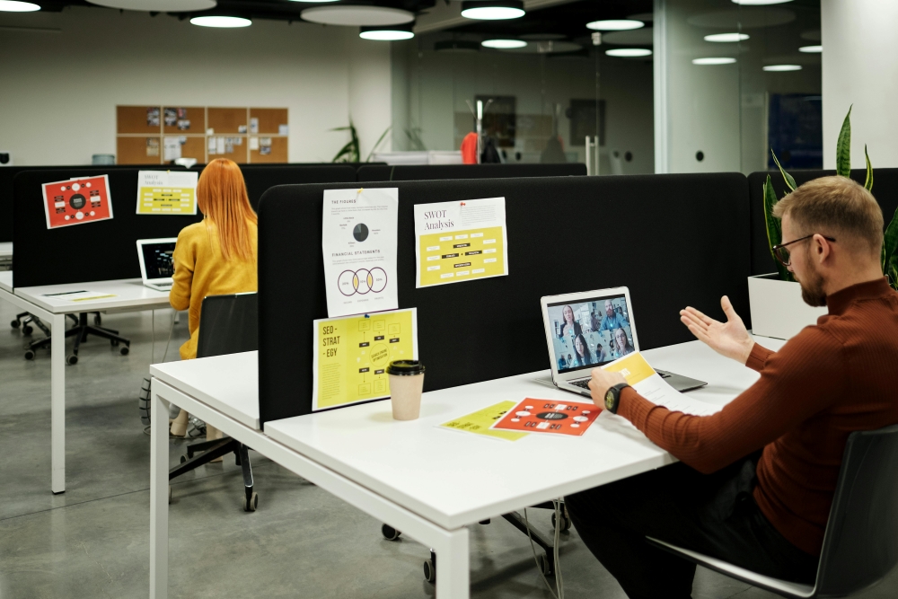 A young man in an office on a zoom call